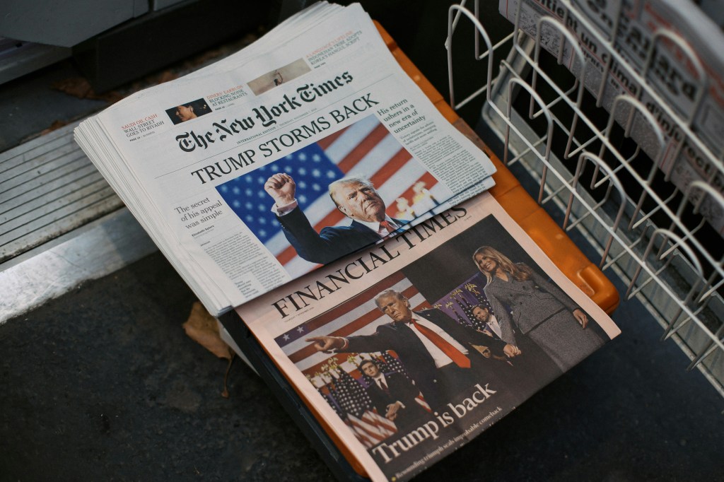 Copies of the New York and Financial Times. The former reads, Trump storms back, and the latter says, Trump is back.