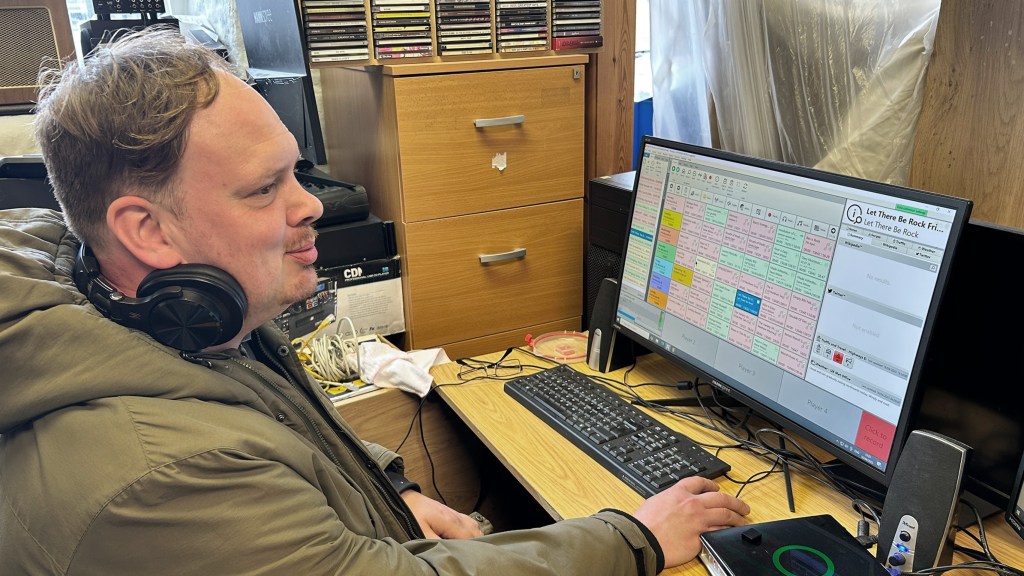Wayne Martyn is seen watching over running orders of the station. The desk is still messy and work was being done around him, but Phoenix wanted to stay on air. 